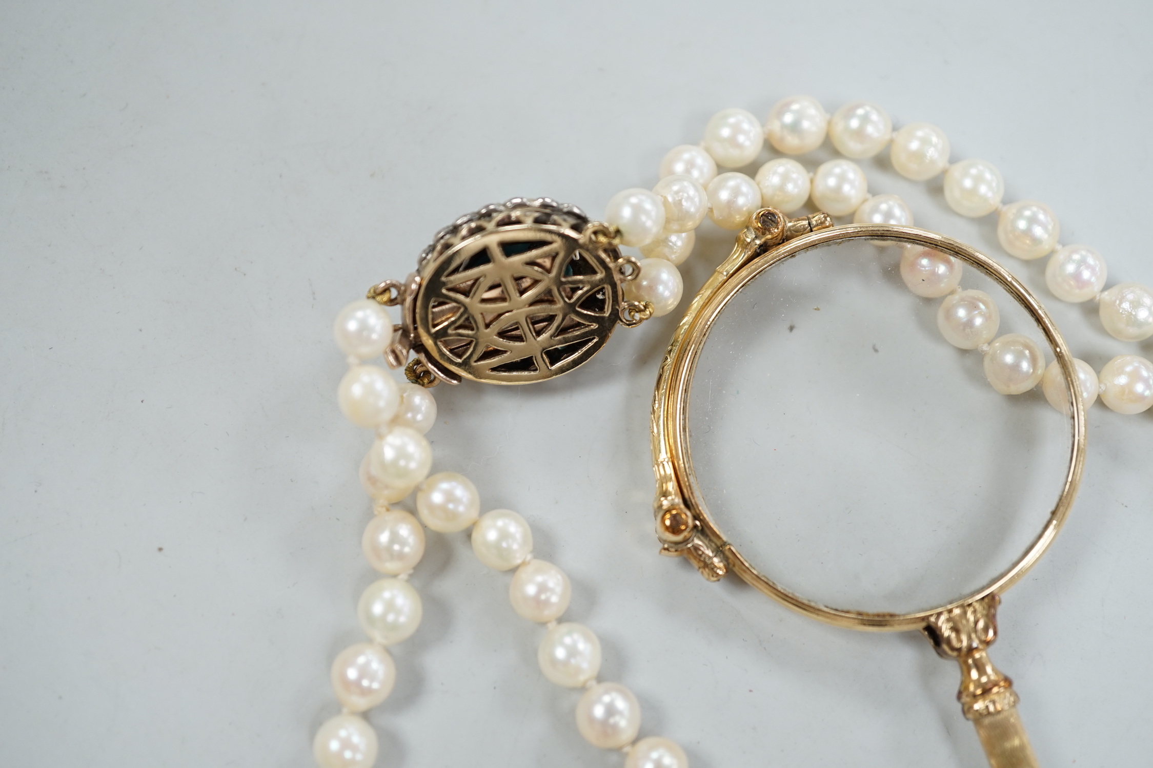 A twin strand cultured pearl choker necklace with yellow metal, blue enamel and diamond cluster set clasp, 36cm, together with a pair of yellow metal overlaid lorgnettes.
